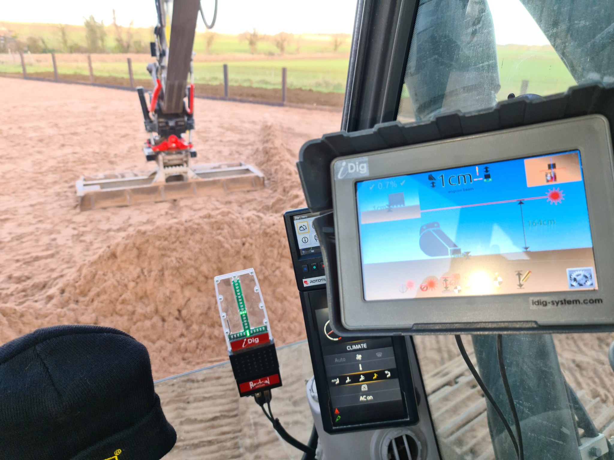 Machine control screen in the cab while levelling arena sand