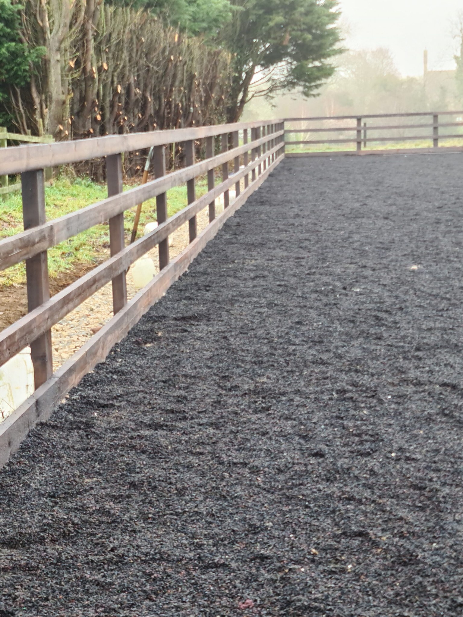 Finished rubber surface arena with post and rail fencing