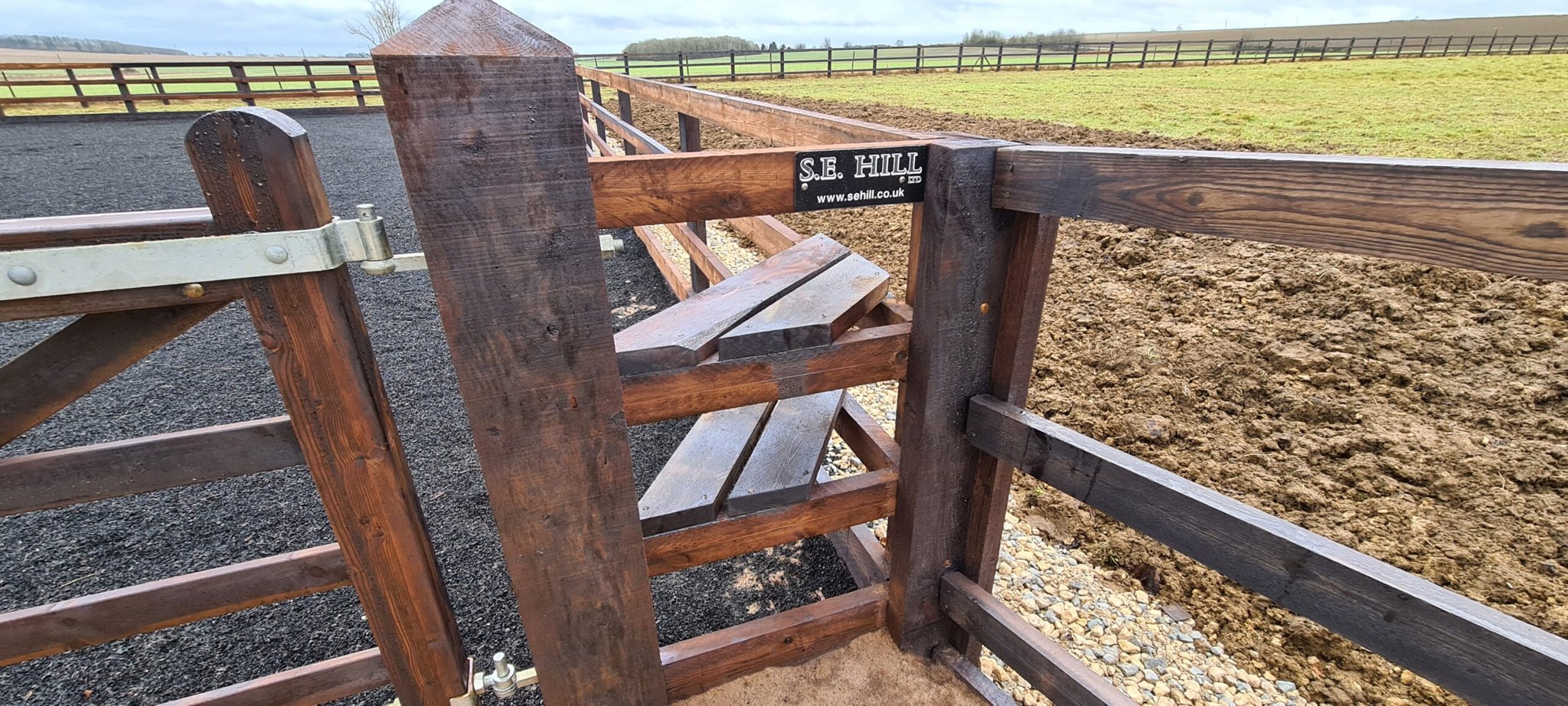 Timber mounting block built into the arena fence