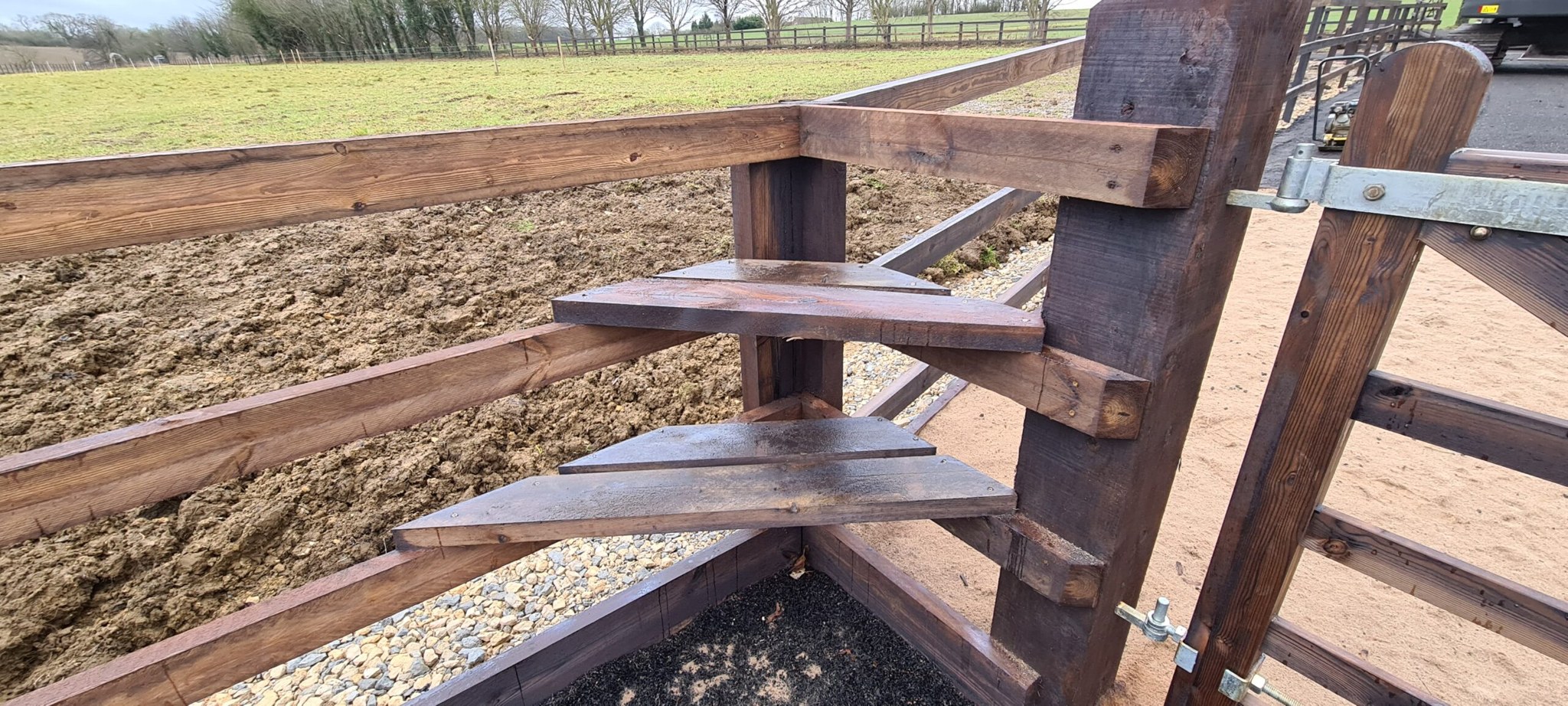 Mounting block steps set into an arena fence
