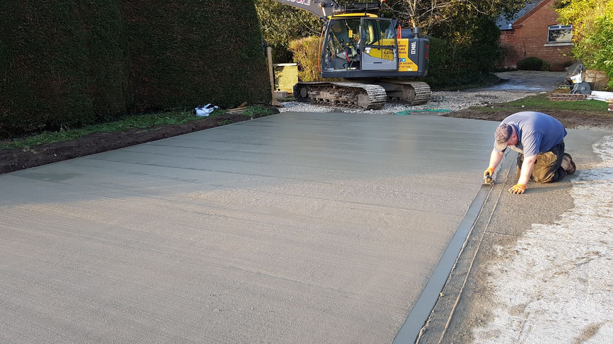 Concrete slab being finished by hand
