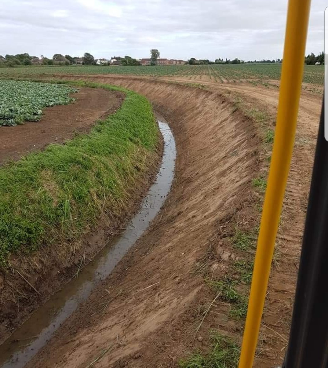 Freshly cleaned ditch seen from the cab